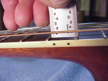 This is how luthiers check the action on a guitar.